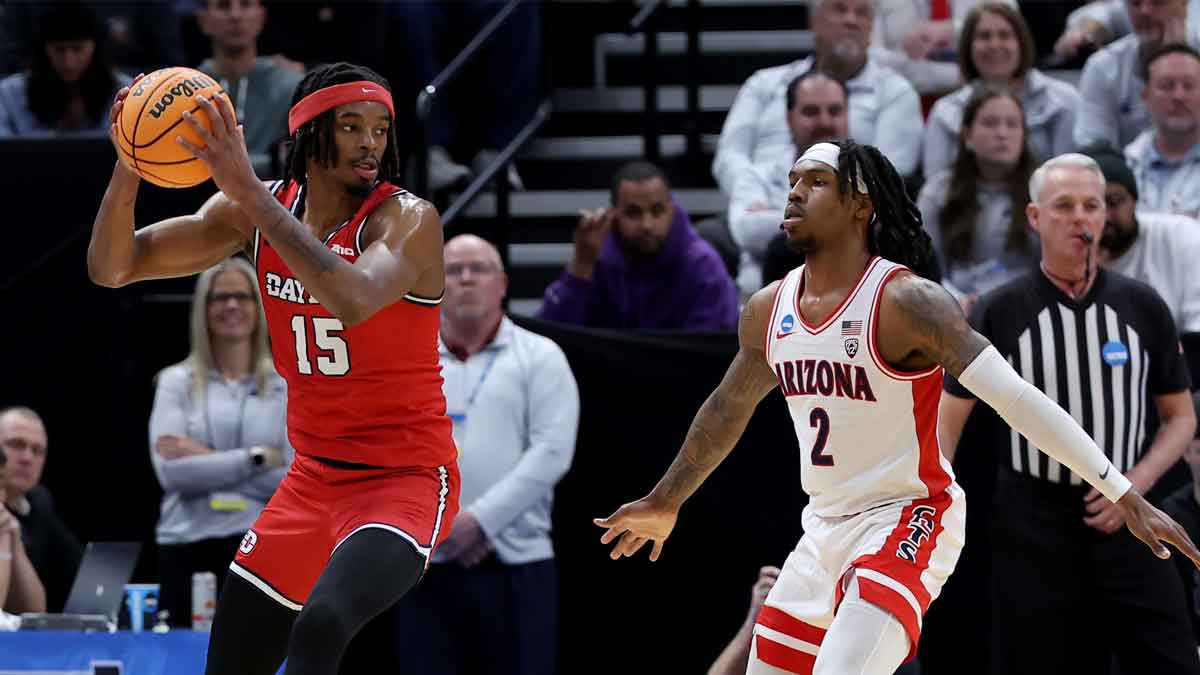 Dayton Flyers forward DaRon Holmes II (15) looks to pass against Arizona Wildcats guard Caleb Love (2) during the first half in the second round of the 2024 NCAA Tournament at Vivint Smart Home Arena-Delta Center.