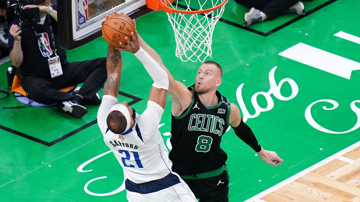 Boston Celtics center Kristaps Porzingis (8) blocks Dallas Mavericks center Daniel Gafford (21) in the third quarter during game two of the 2024 NBA Finals at TD Garden.